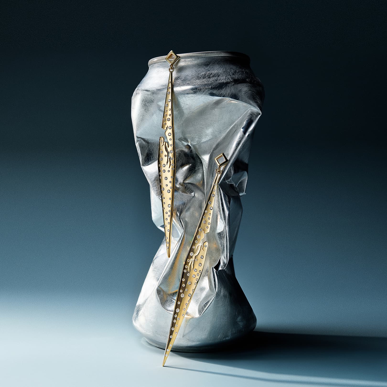 Metallic boot with gold decorative elements on a dark background