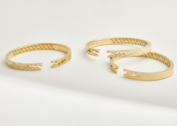 Gold bracelets on white background
