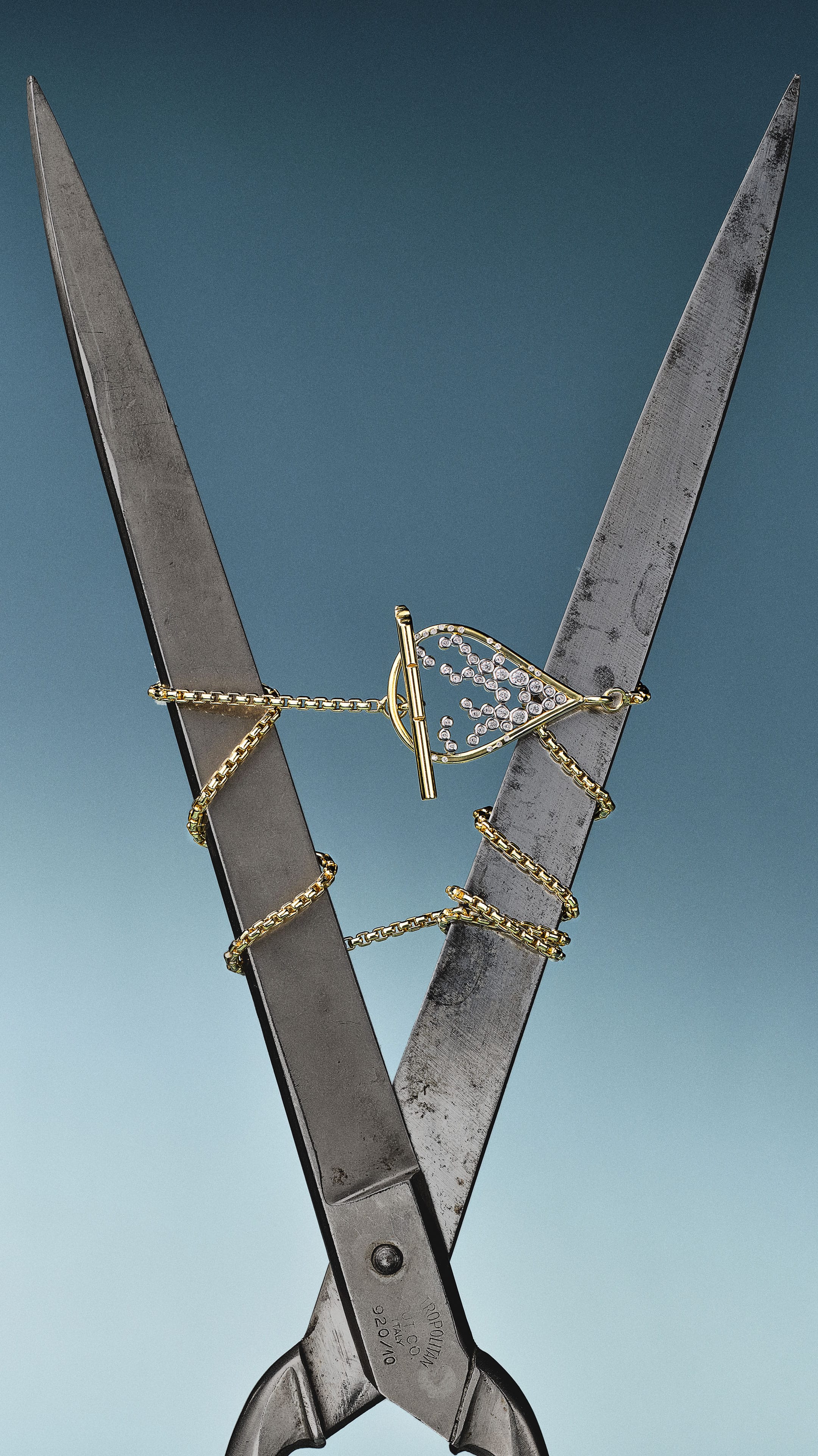 Gold necklace between two scissors