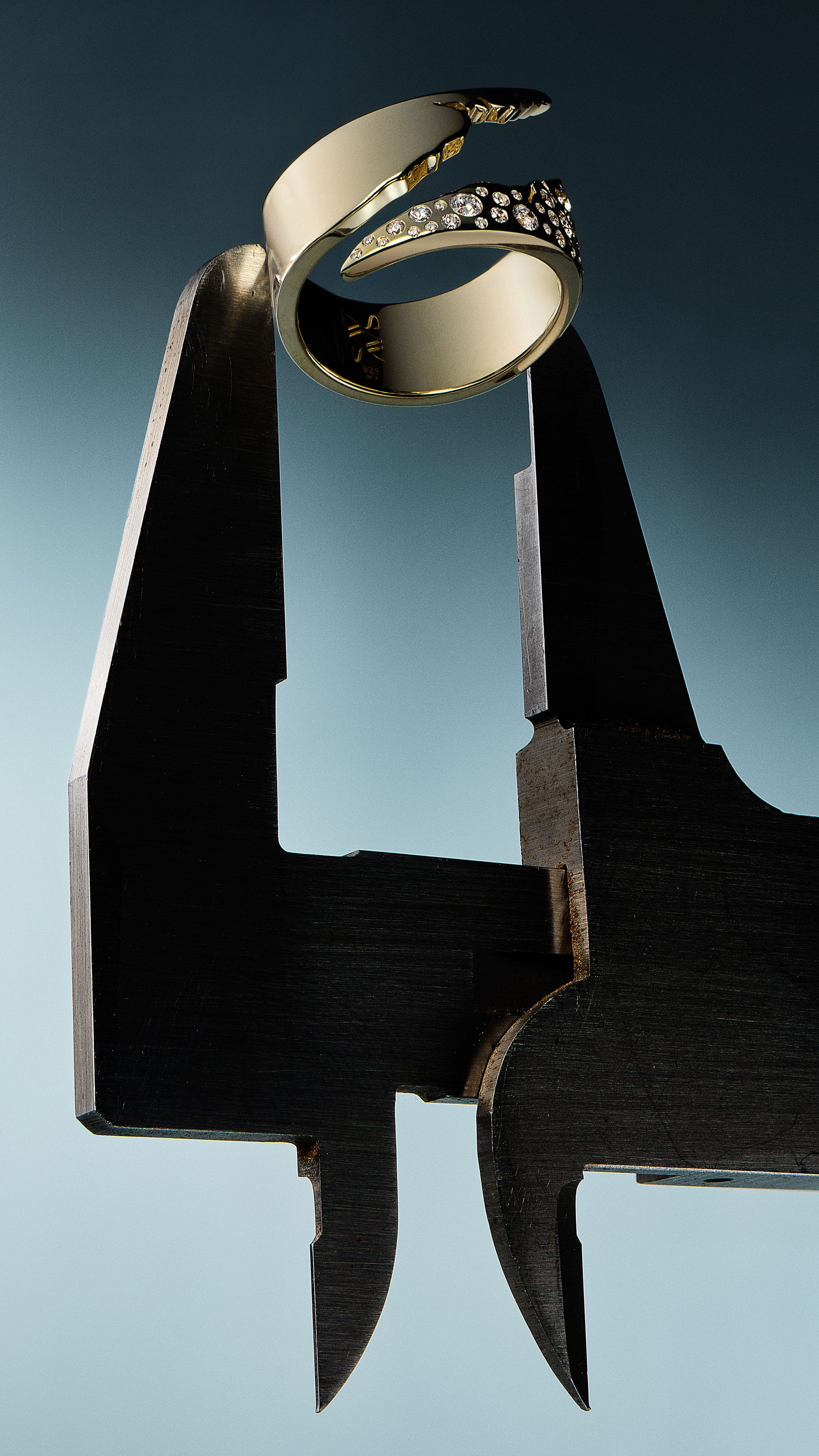 Gold ring held by a tool