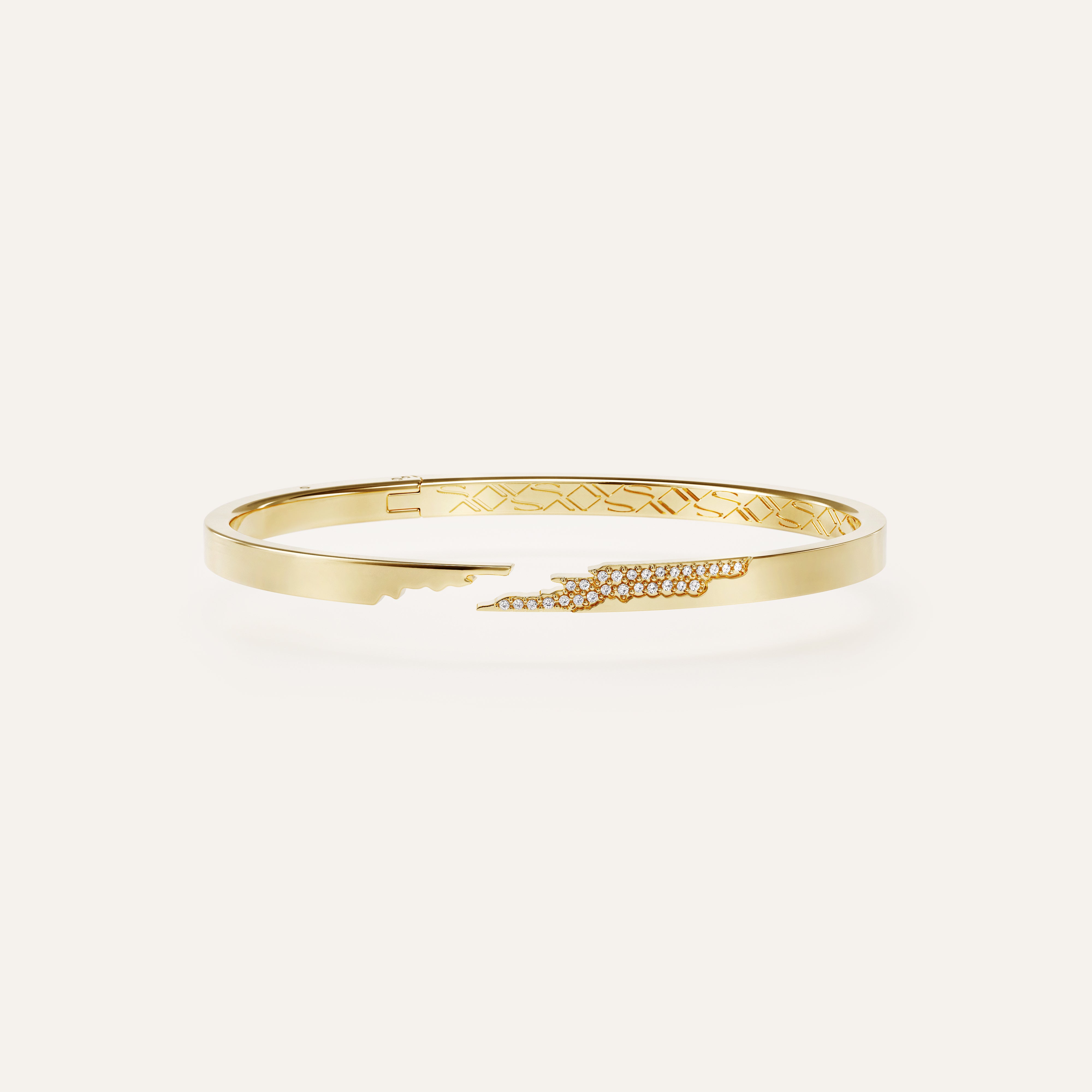 Gold bracelet with intricate design on a white background