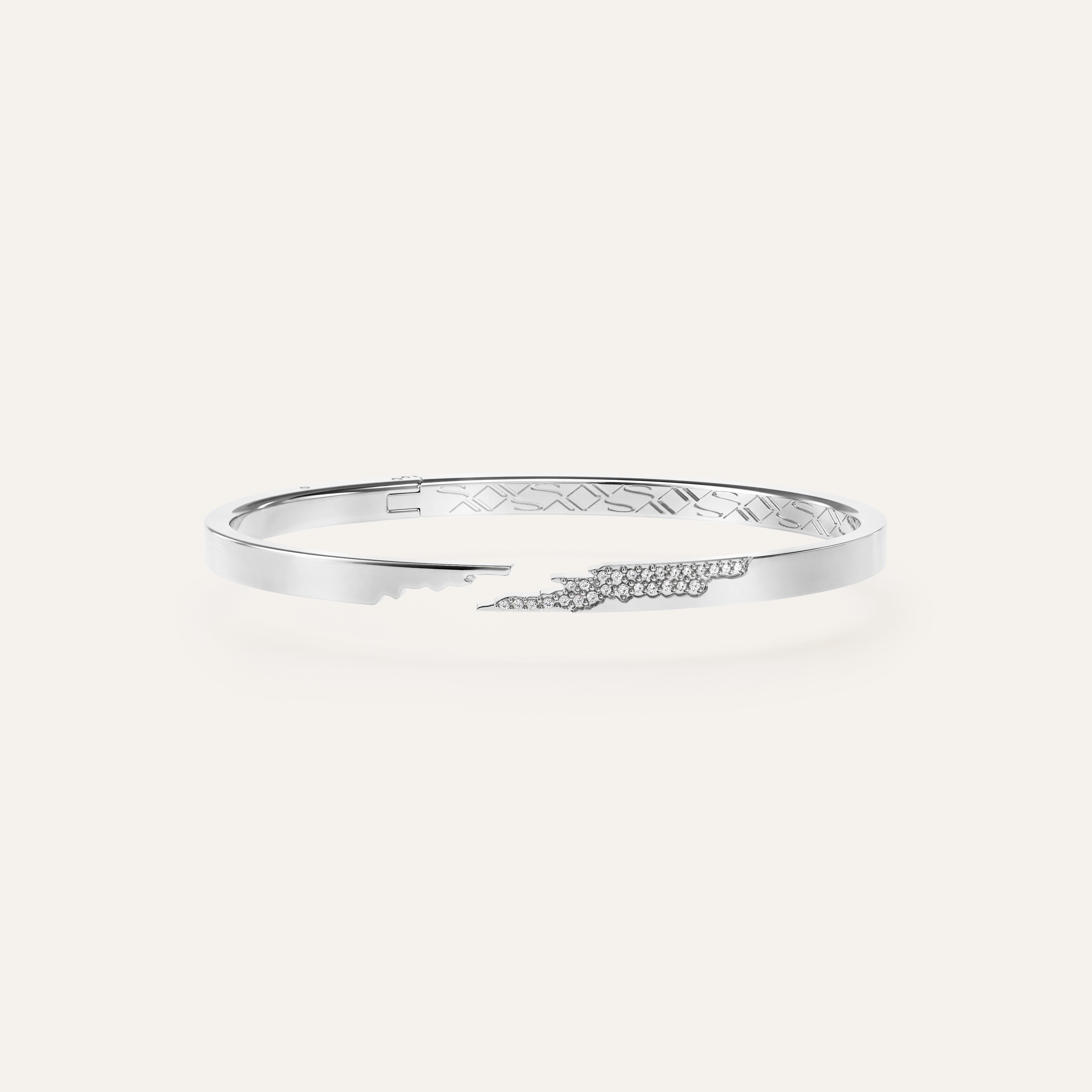 Silver bracelet with engraved design on a white background