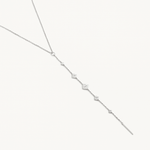 Silver necklace with small diamond-like pendants on a white background