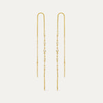 A pair of gold threader earrings with diamonds, featuring fine gold strands threaded through the ear with small diamonds attached along the length.