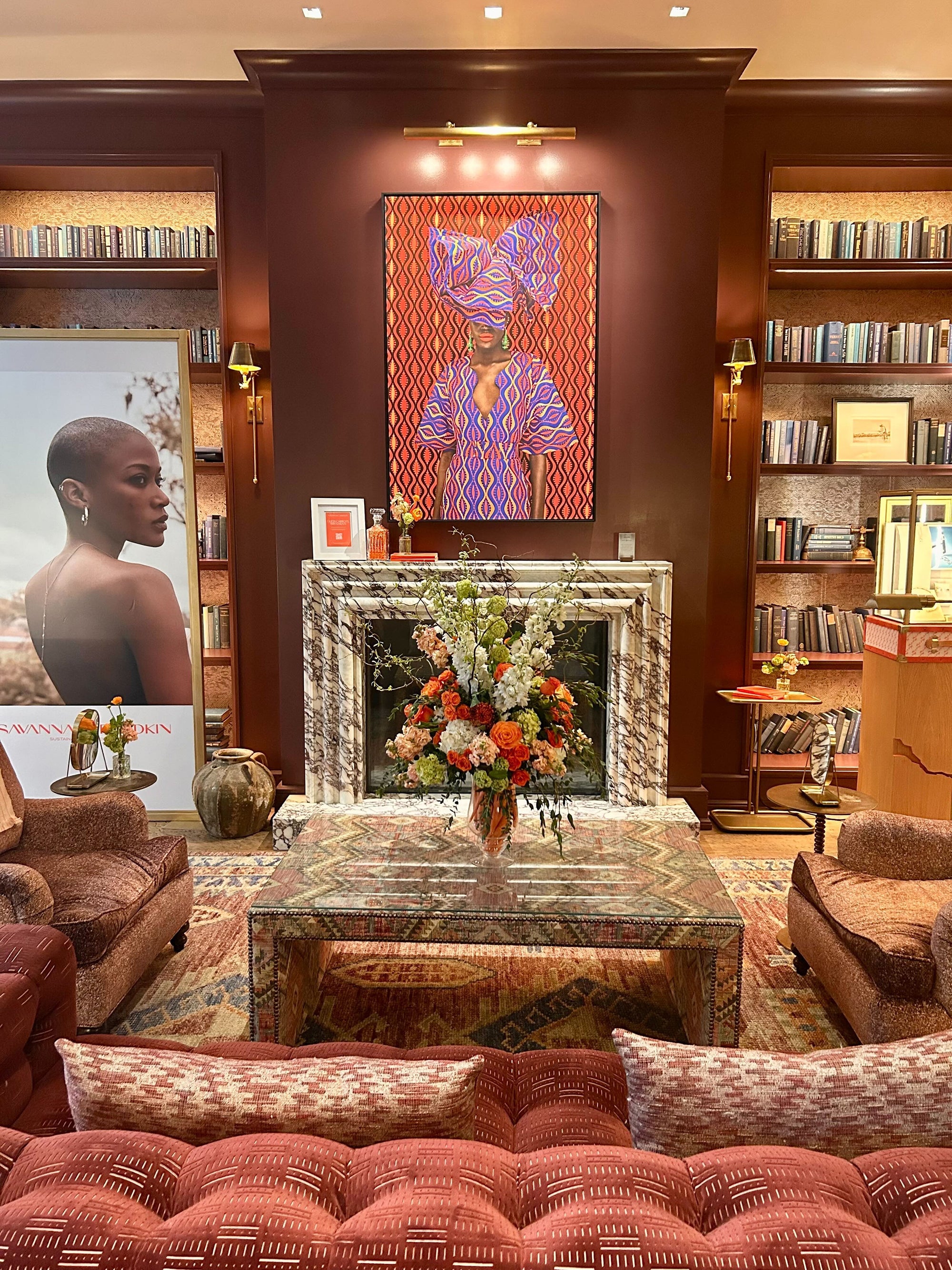 Luxurious living room with a fireplace, bookshelves, and decorative elements.