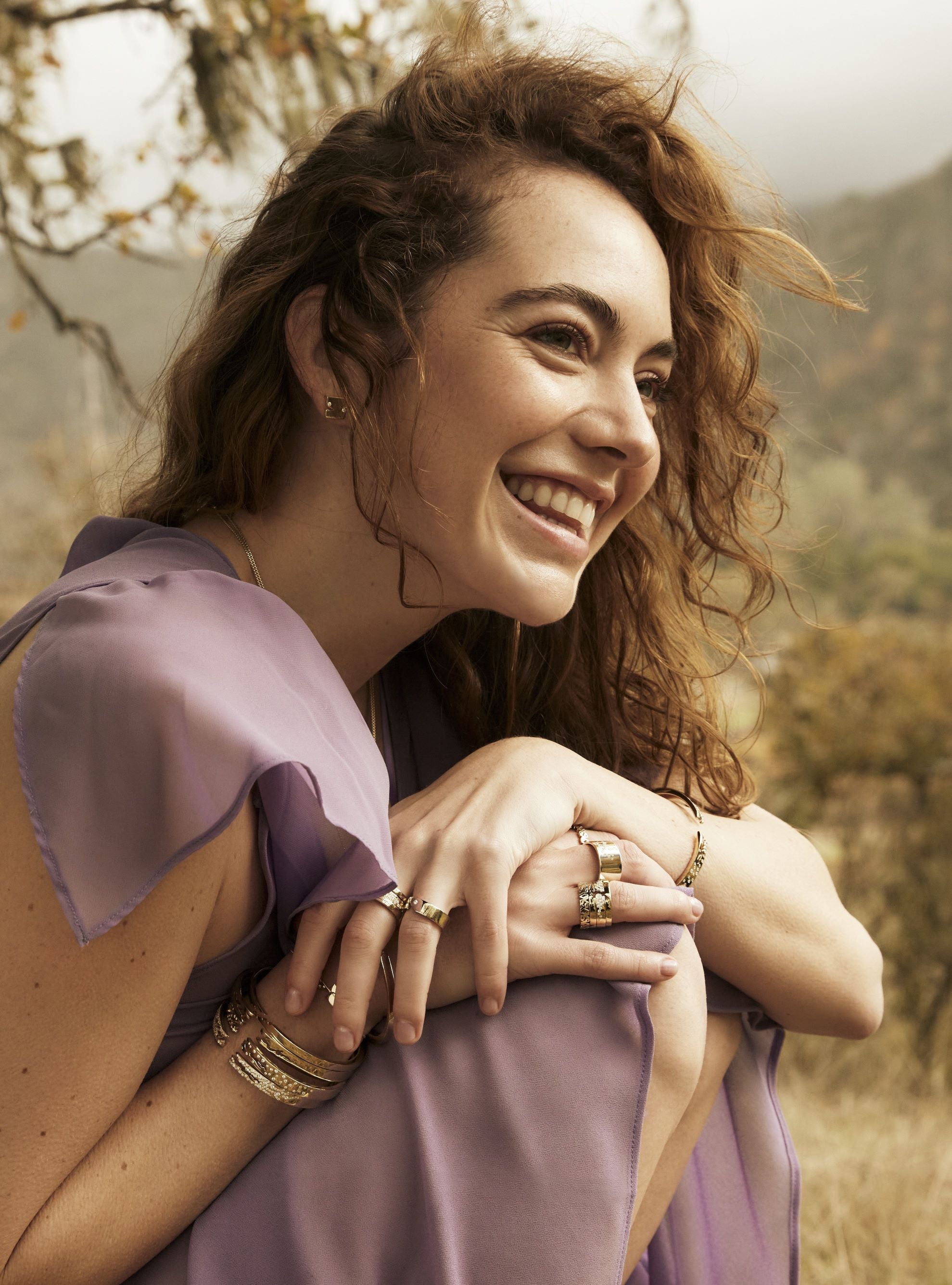 Woman wearing gold jewelry outdoors