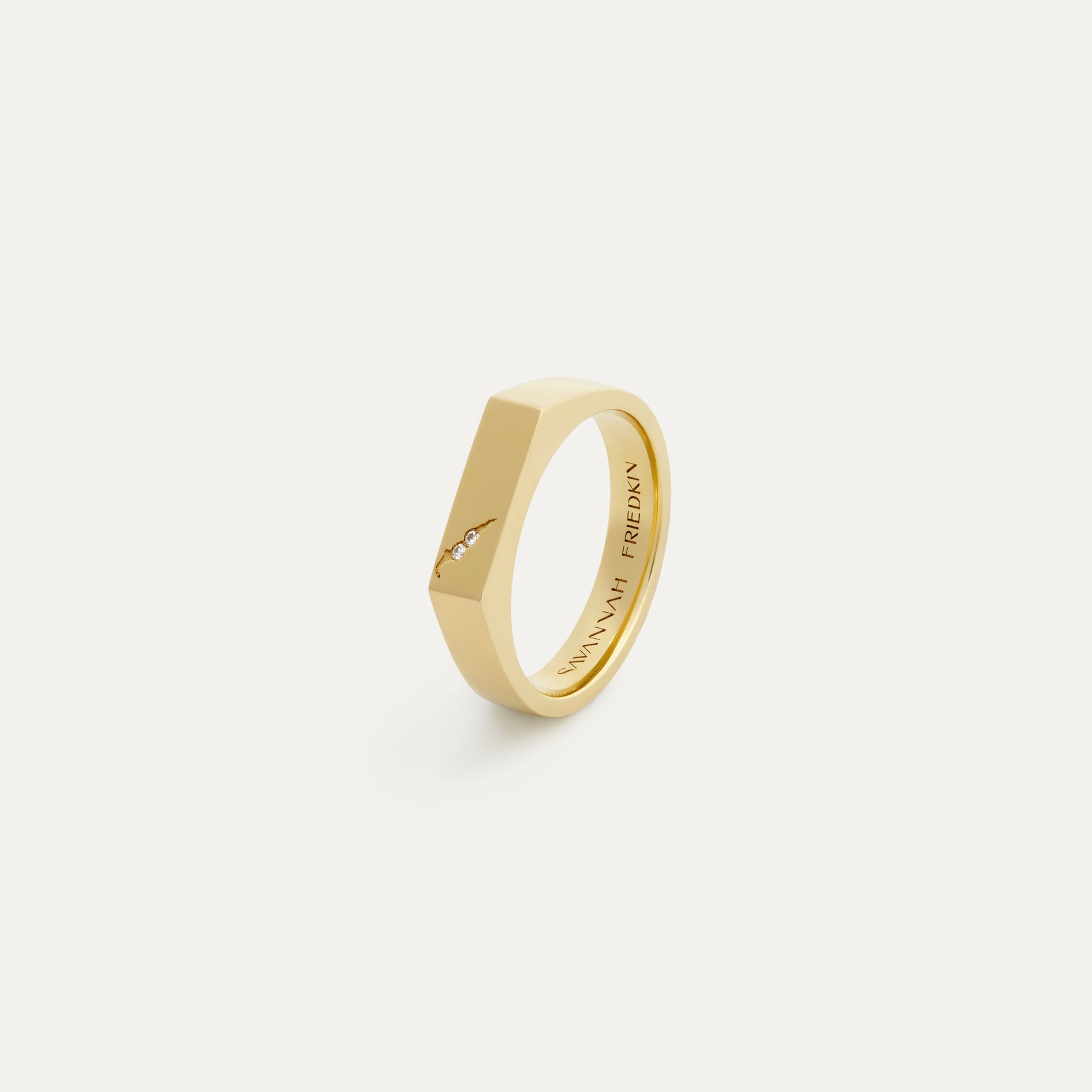A signet ring with a geometric design and pavé diamonds set in a 14k certified recycled yellow gold band.