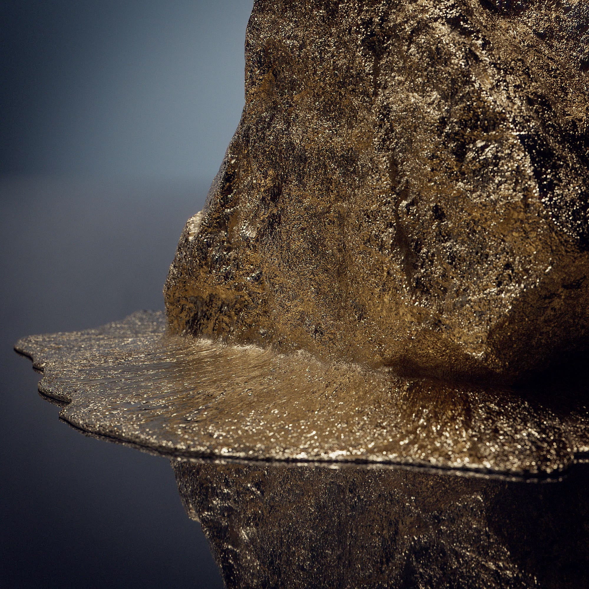 Detail view of precious metal on dark reflective background