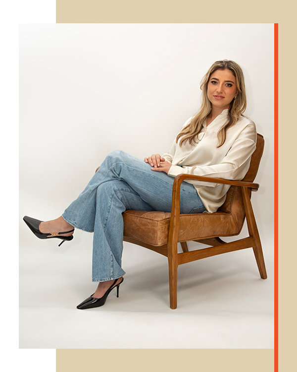 Portrait of woman sitting in chair posing for photo