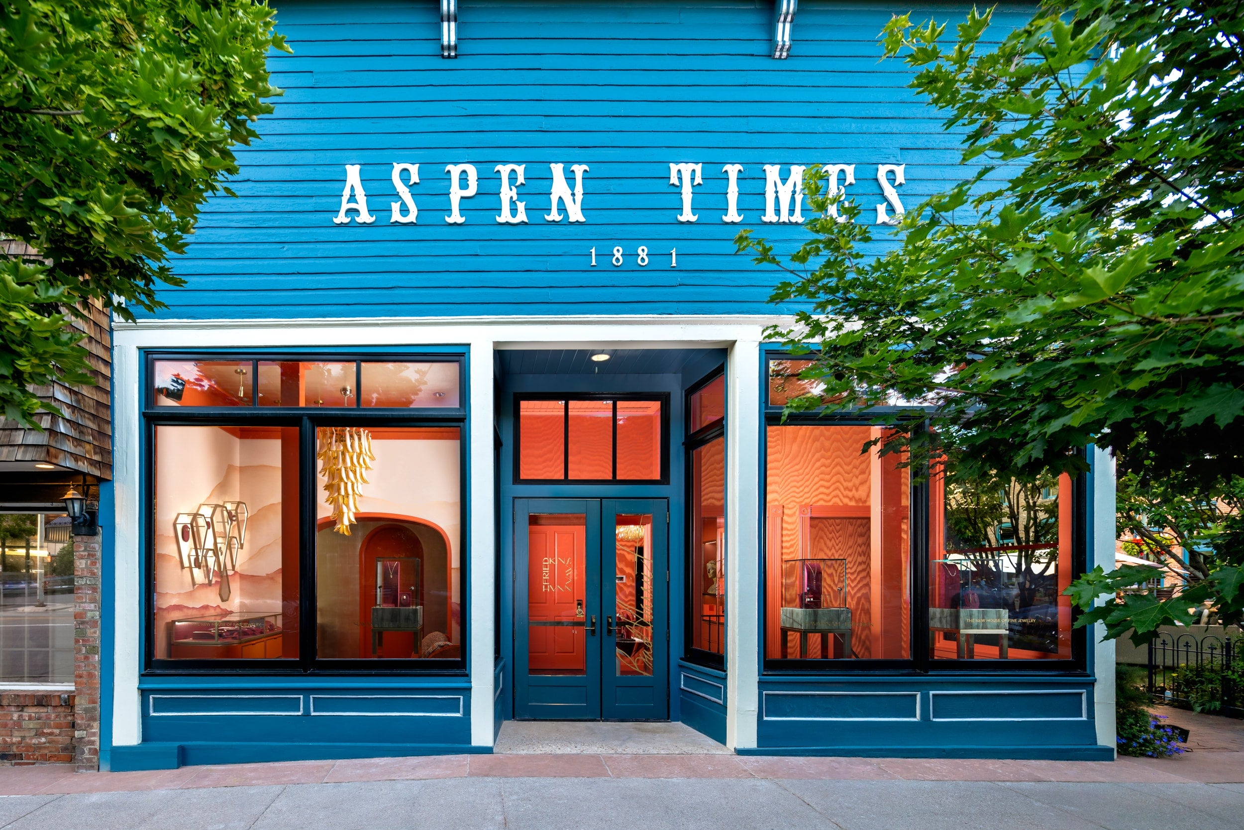 Blue storefront with 'Aspen Times' sign and glass windows