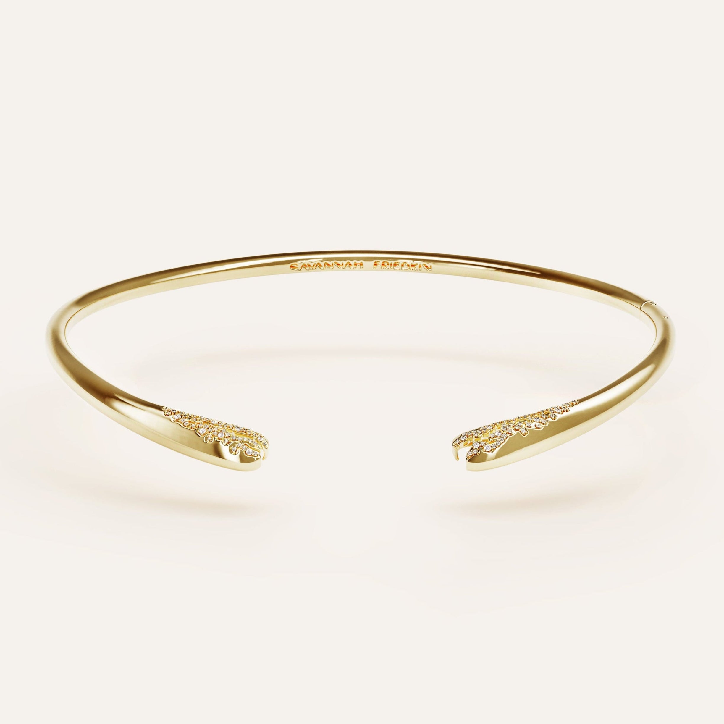 Gold bracelet on a light beige background