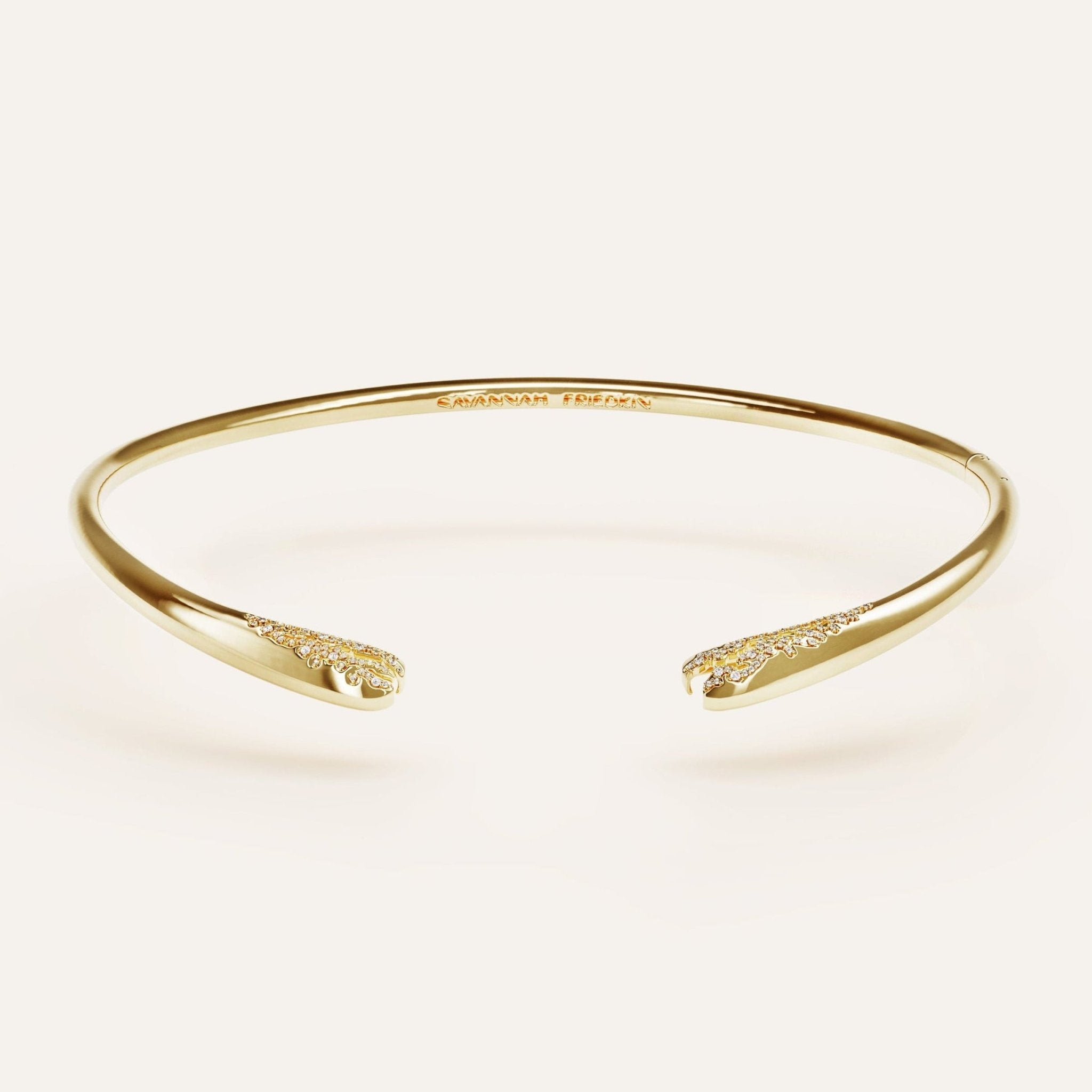 Gold bracelet on a light beige background