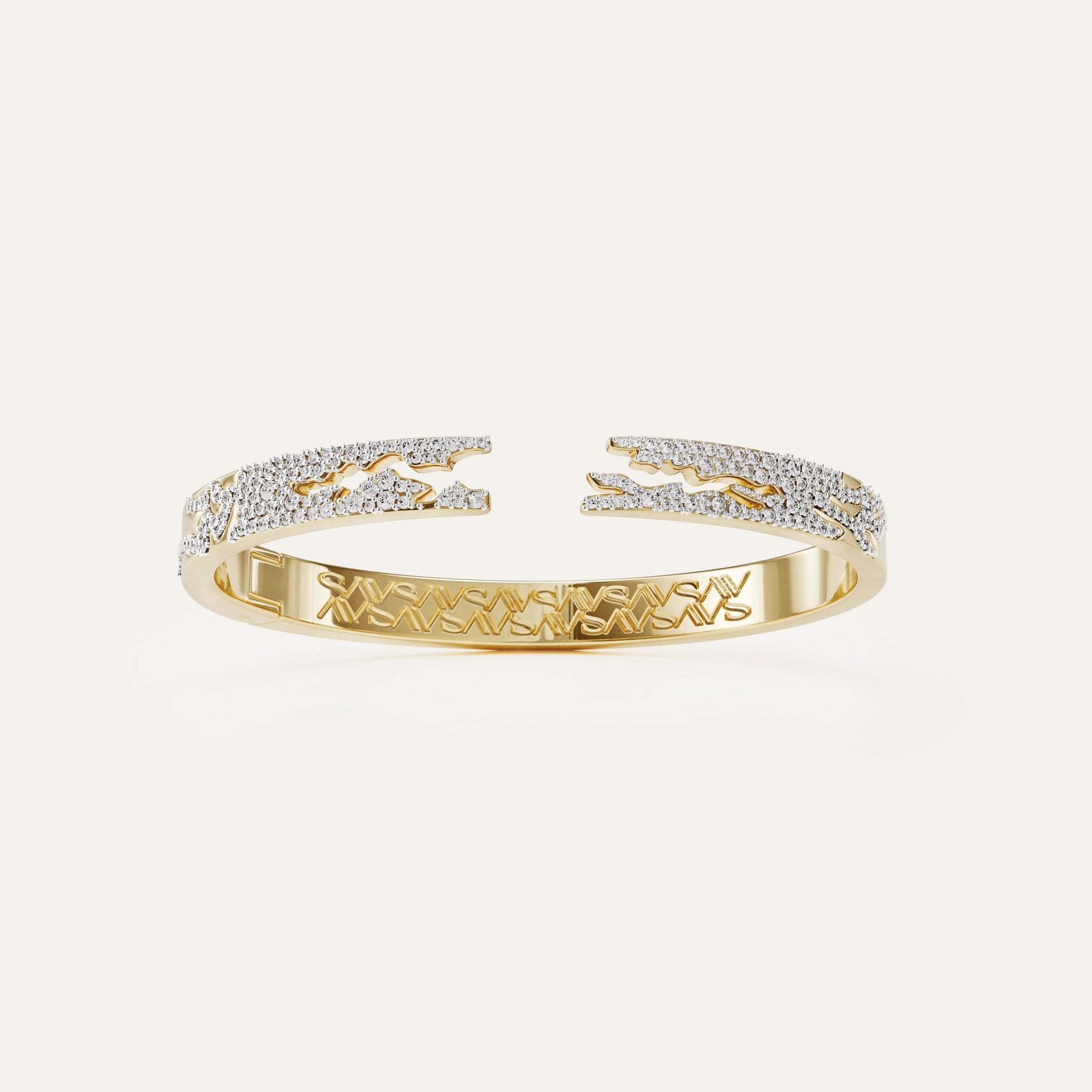 Gold bracelet with diamond accents on a light beige background