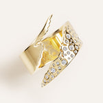 Gold ring with diamond accents on a light background