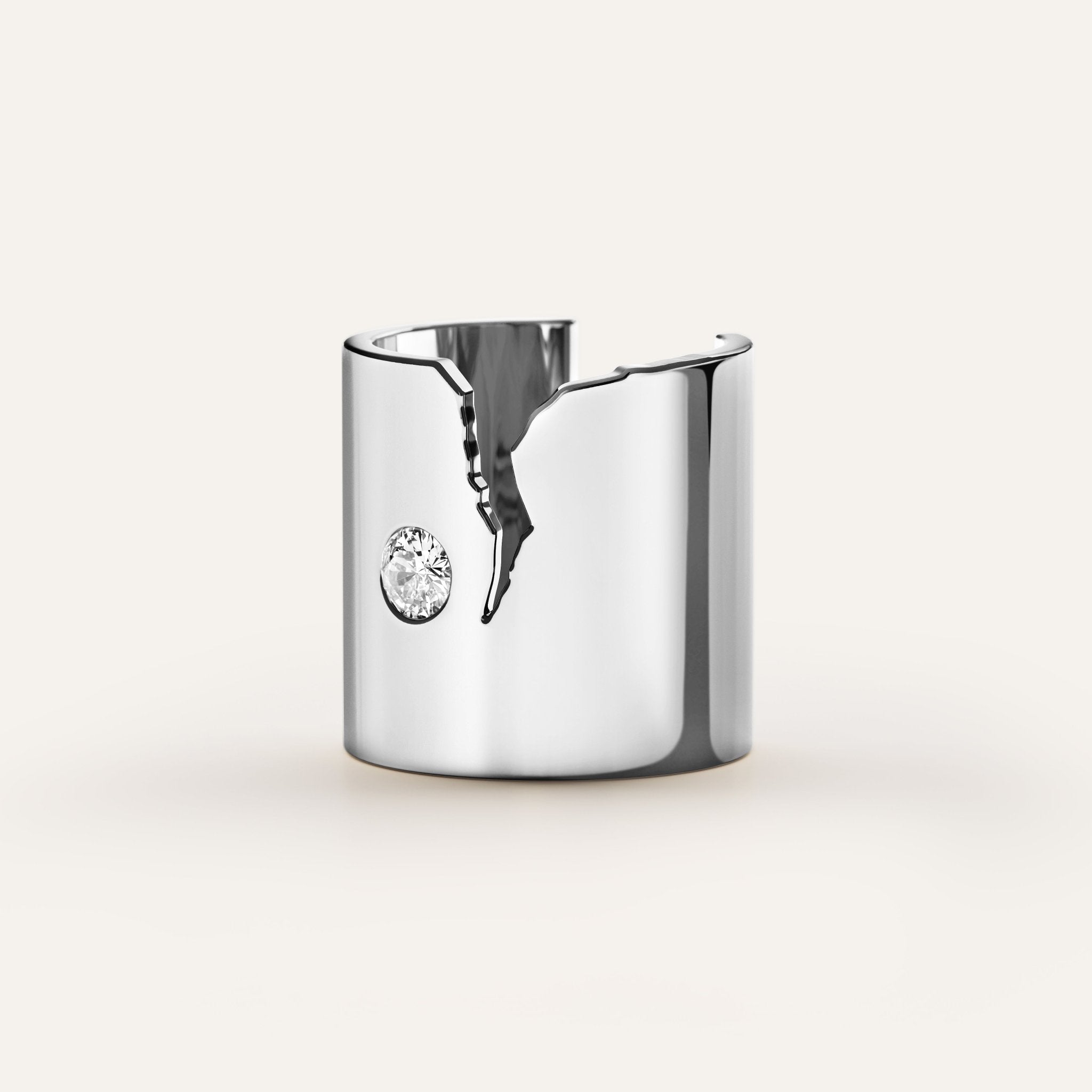 Silver cuff bracelet with a central gemstone on a light gray background