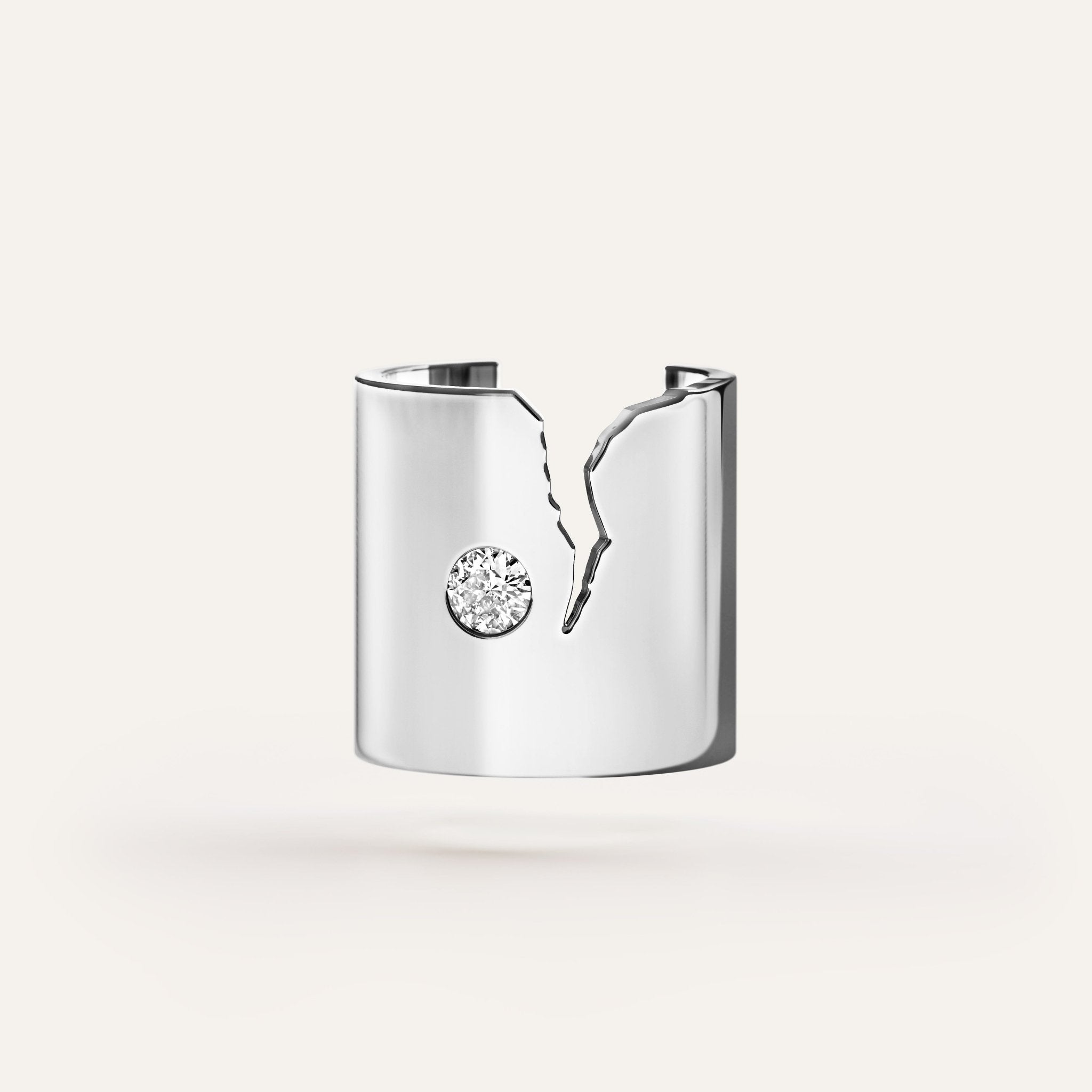 Silver ring with a diamond on a white background