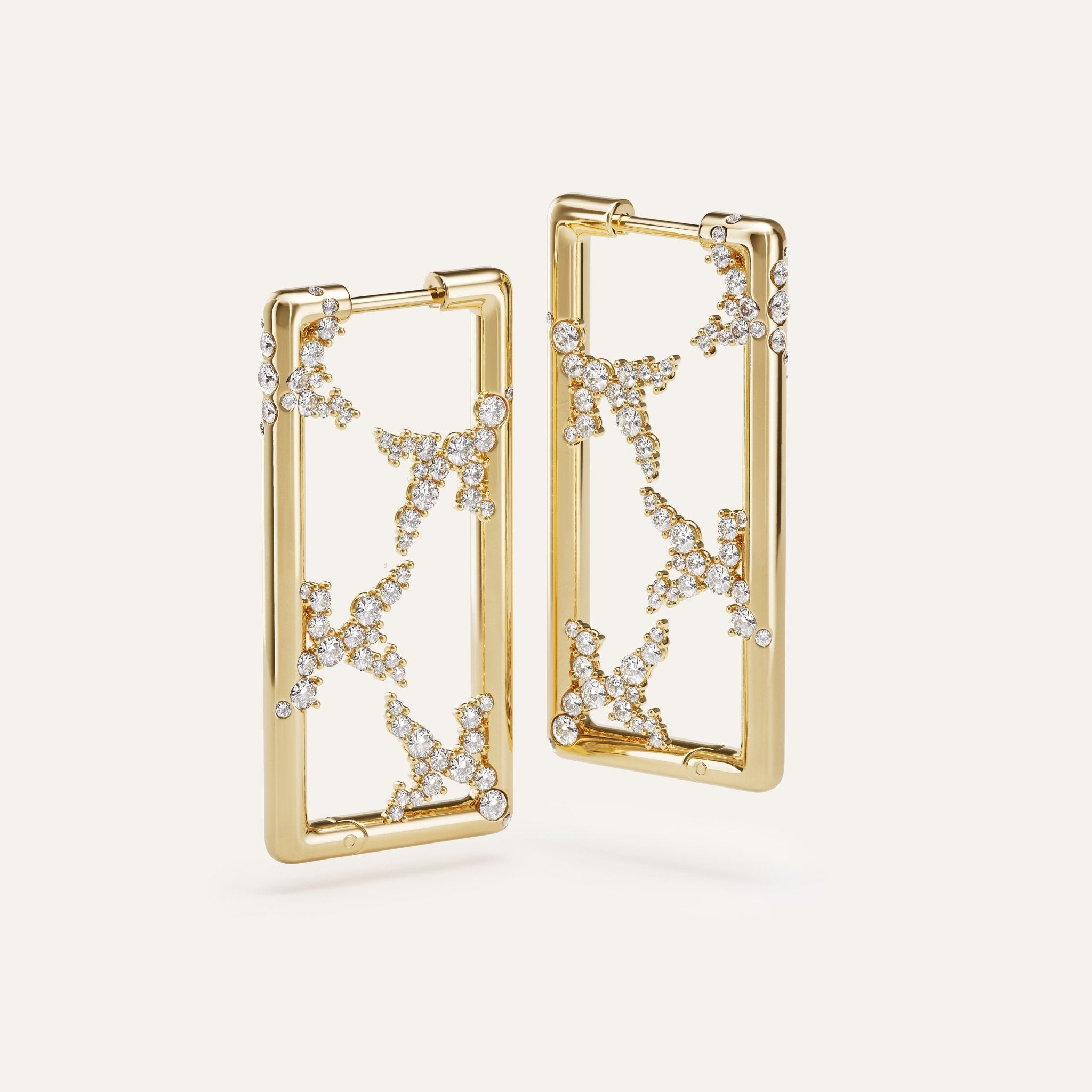 Gold hoop earrings with star designs on a white background