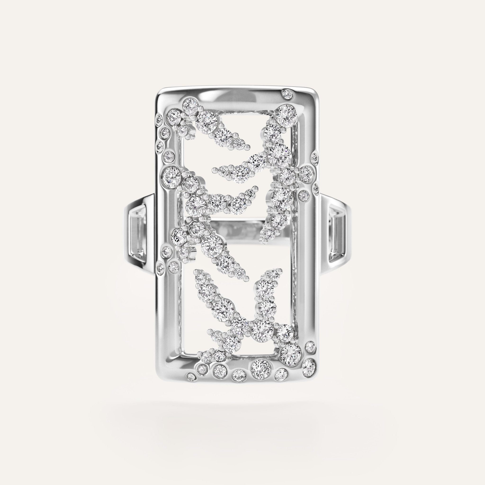 Silver ring with intricate design on a white background