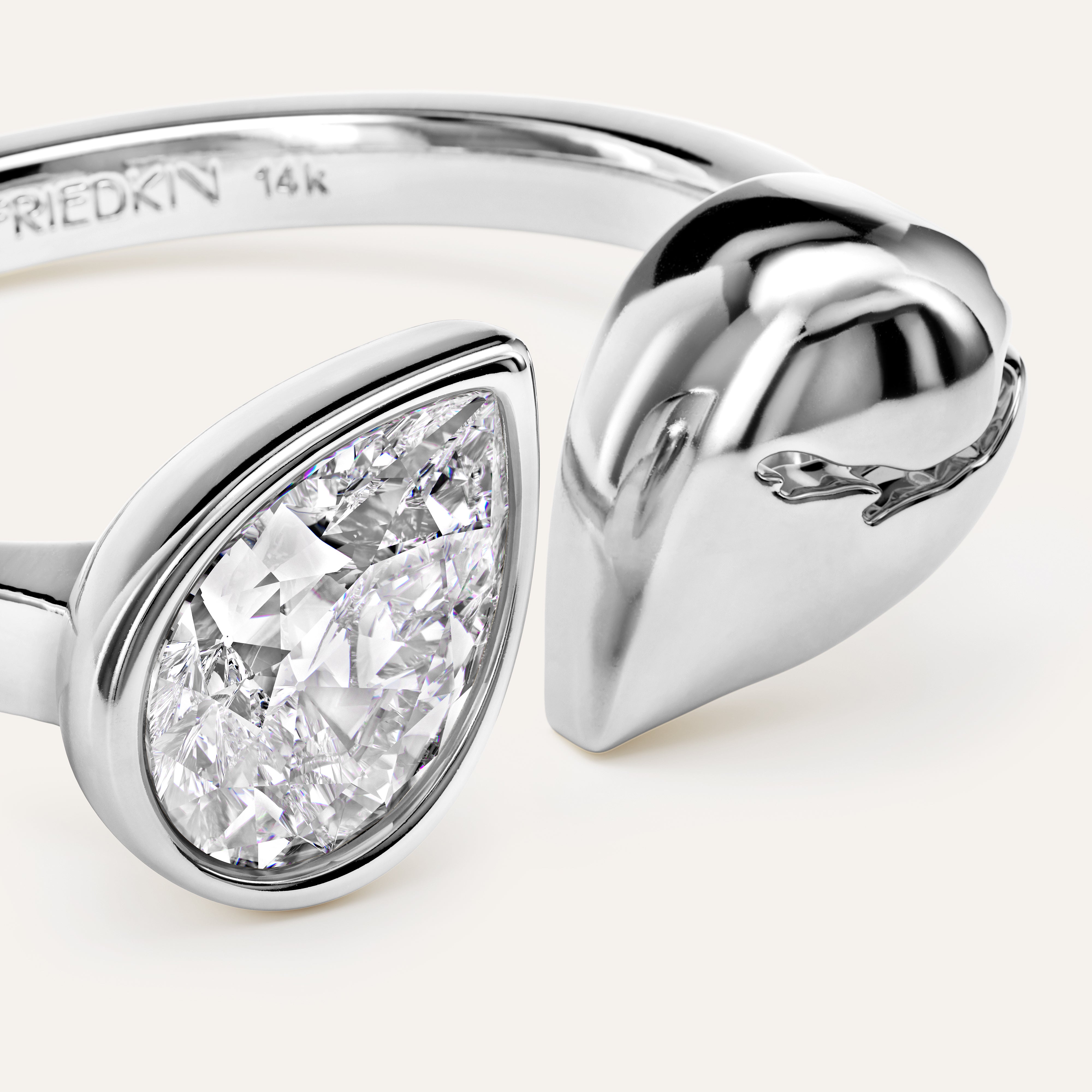 Silver ring with pear-shaped diamond on a white background
