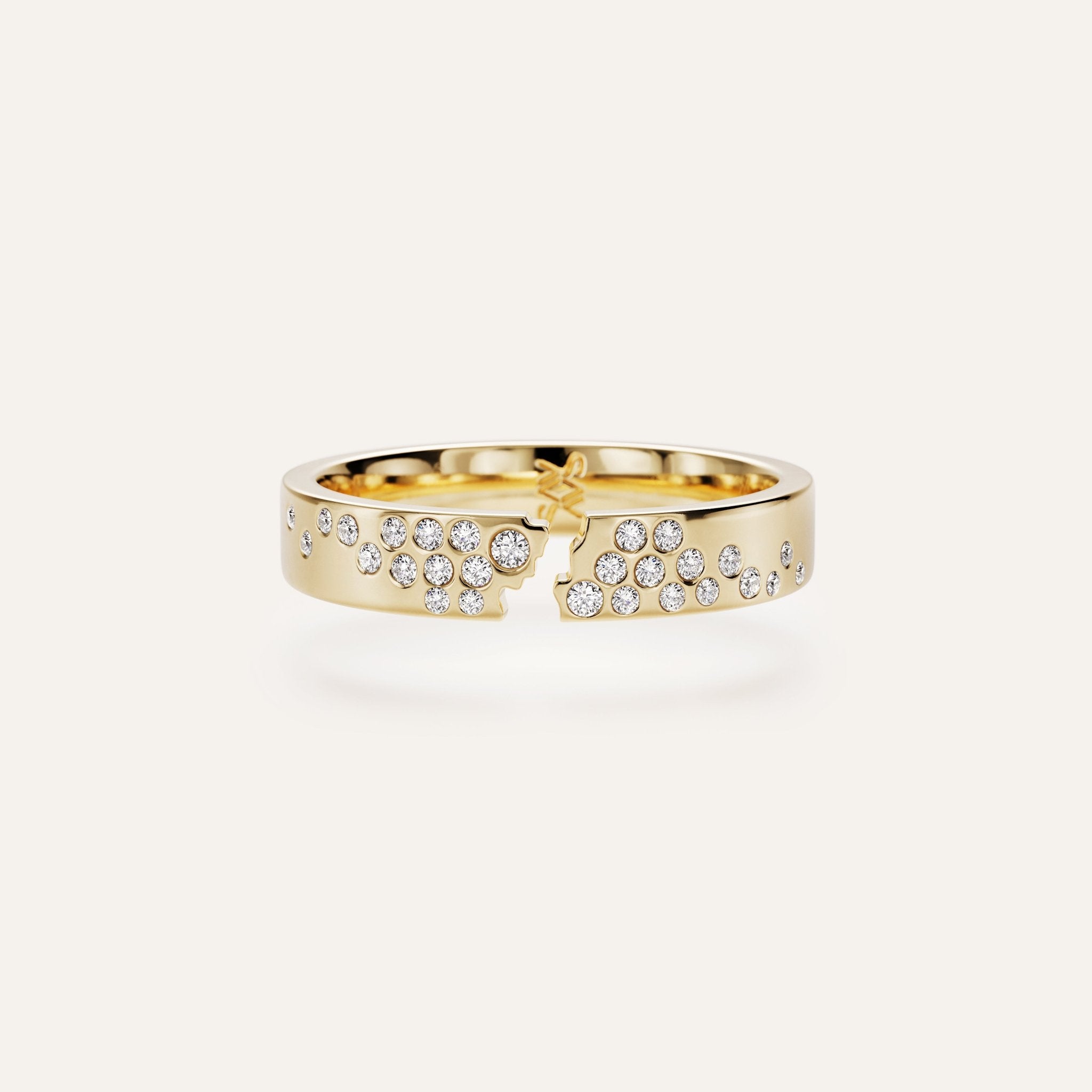 Gold ring with diamond accents on a white background