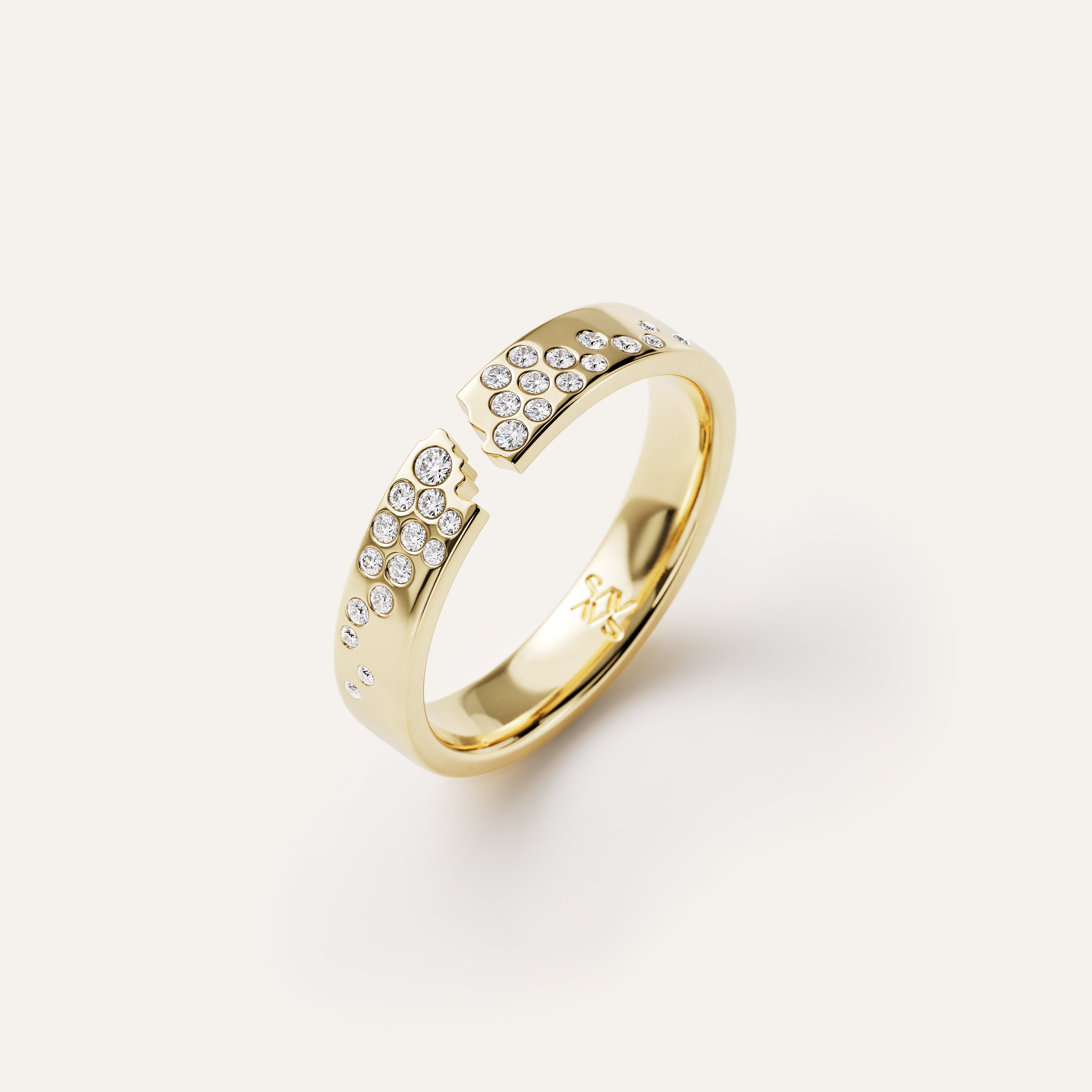 Gold ring with diamond accents on a white background