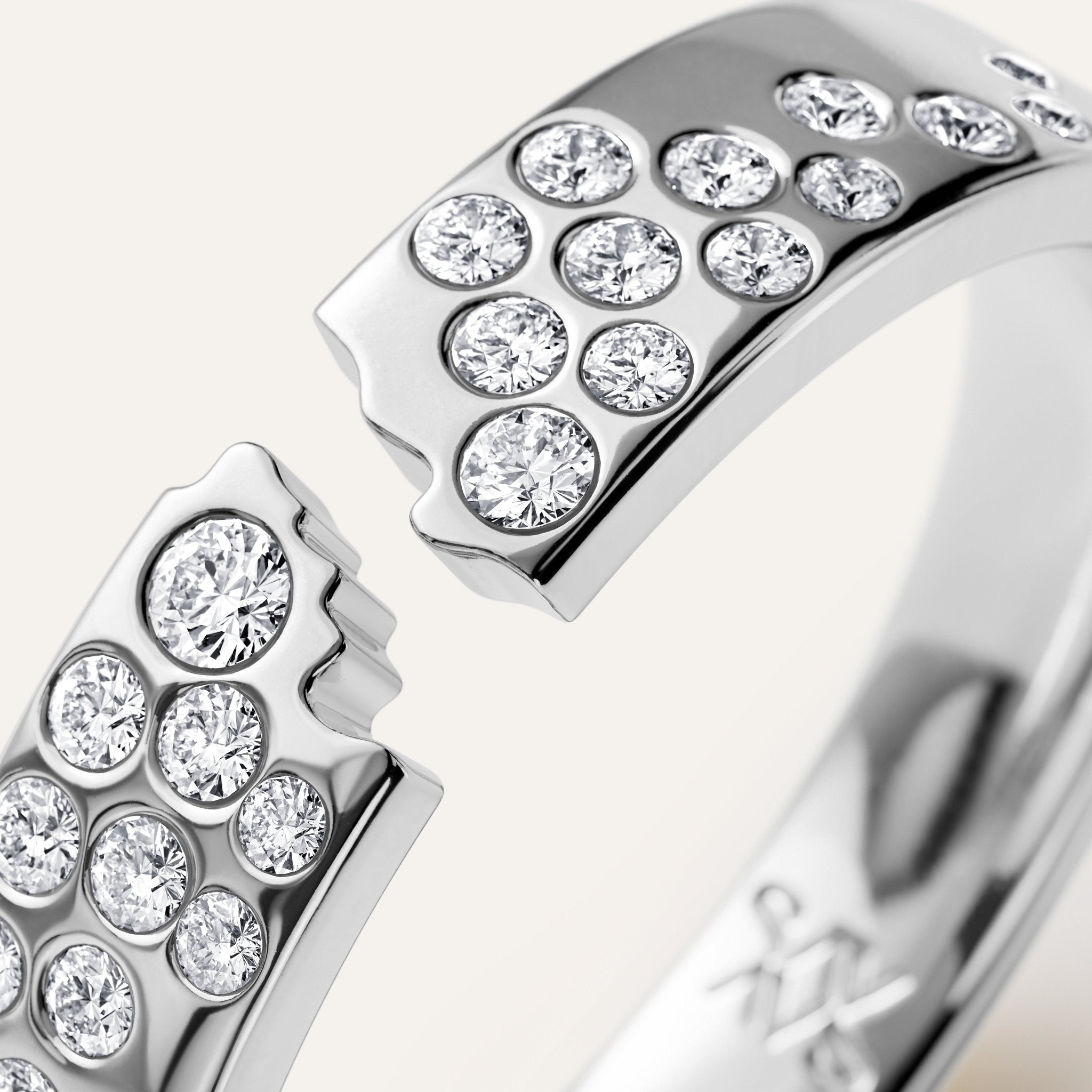 Close-up of a silver ring with diamond accents on a light background