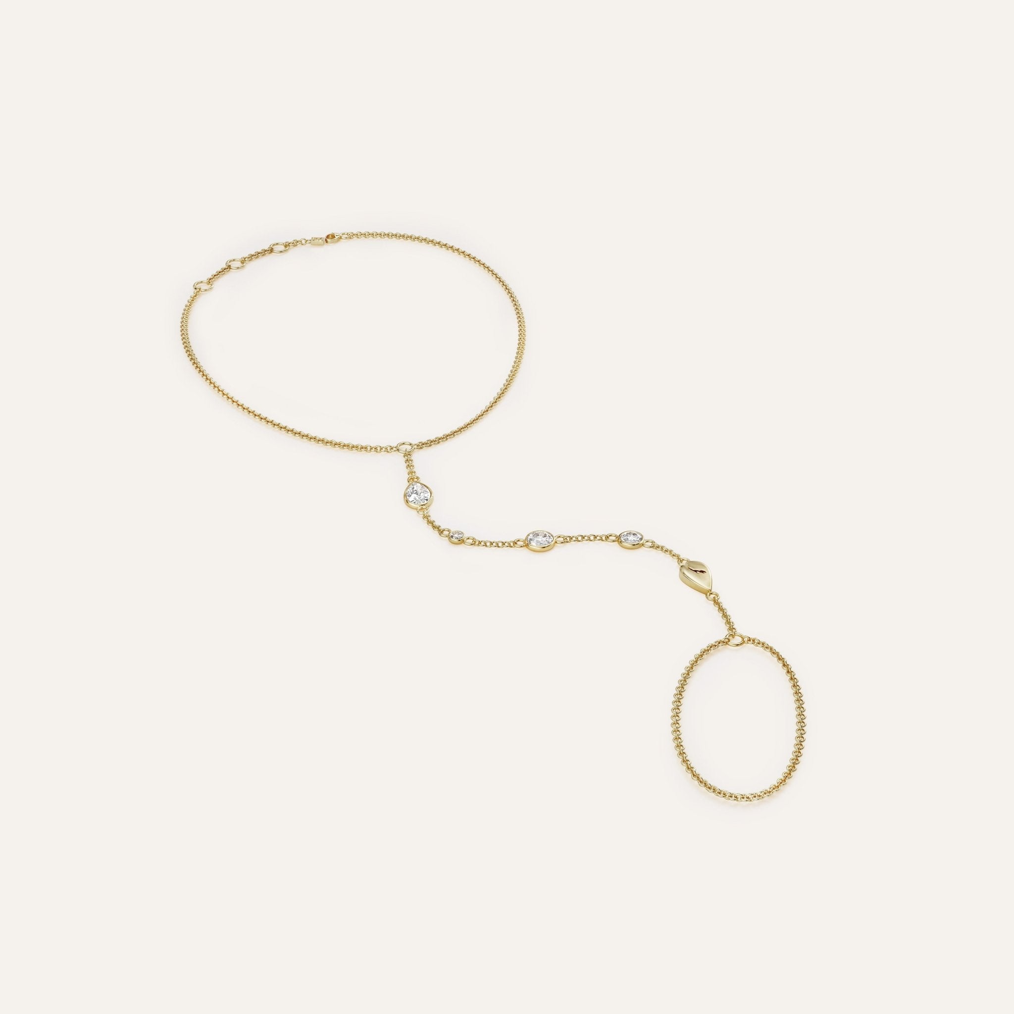 Gold necklace with oval pendants on a light beige background