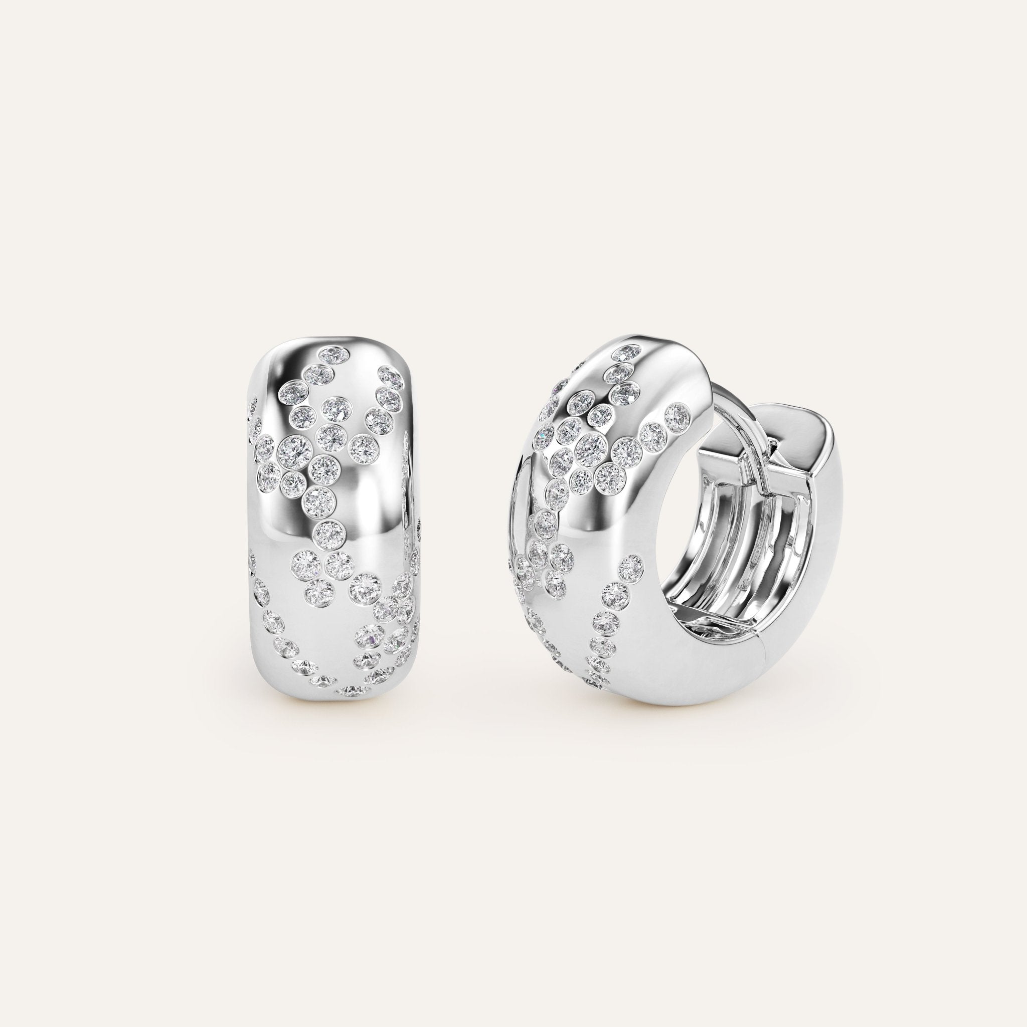 Silver hoop earrings with embedded stones on a light gray background