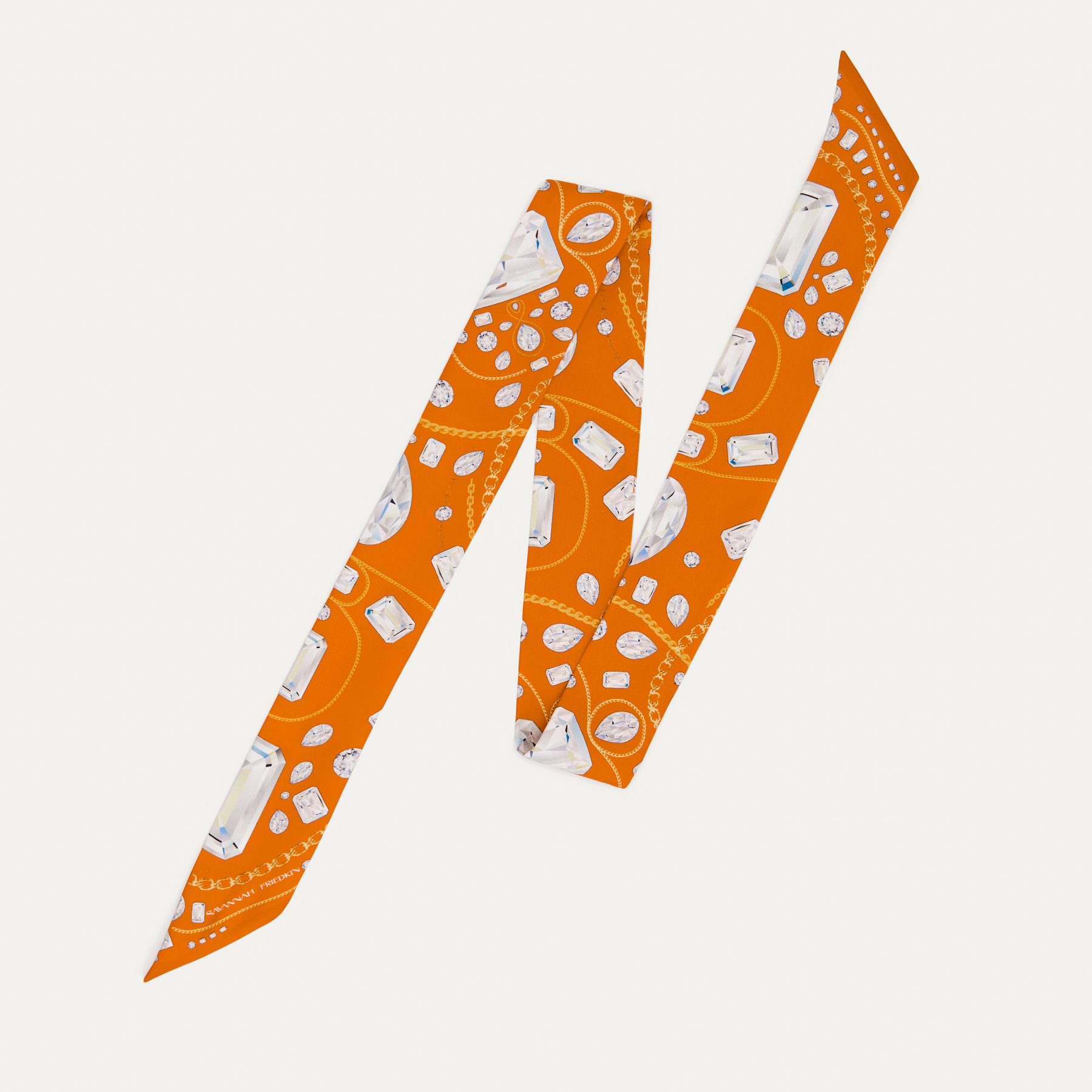 A silk twill scarf with an orange background and a diamond and gold necklace print.