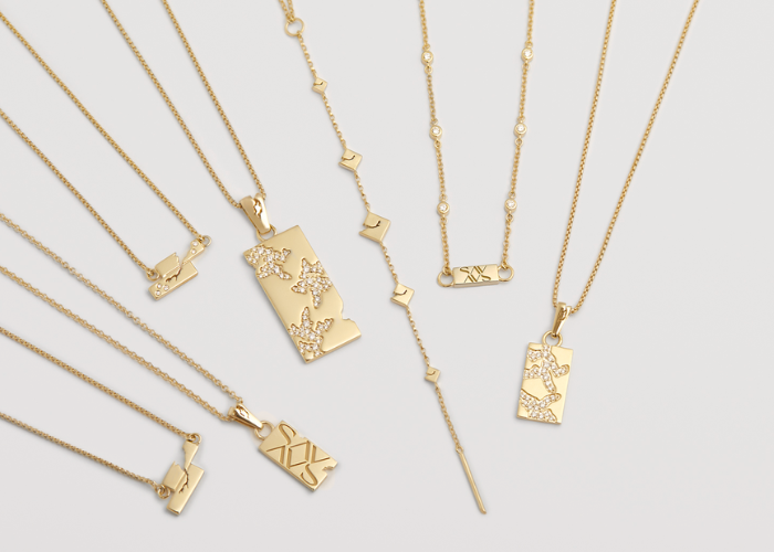 Gold necklaces against a white surface