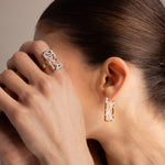 Woman wearing a matching ring and earring