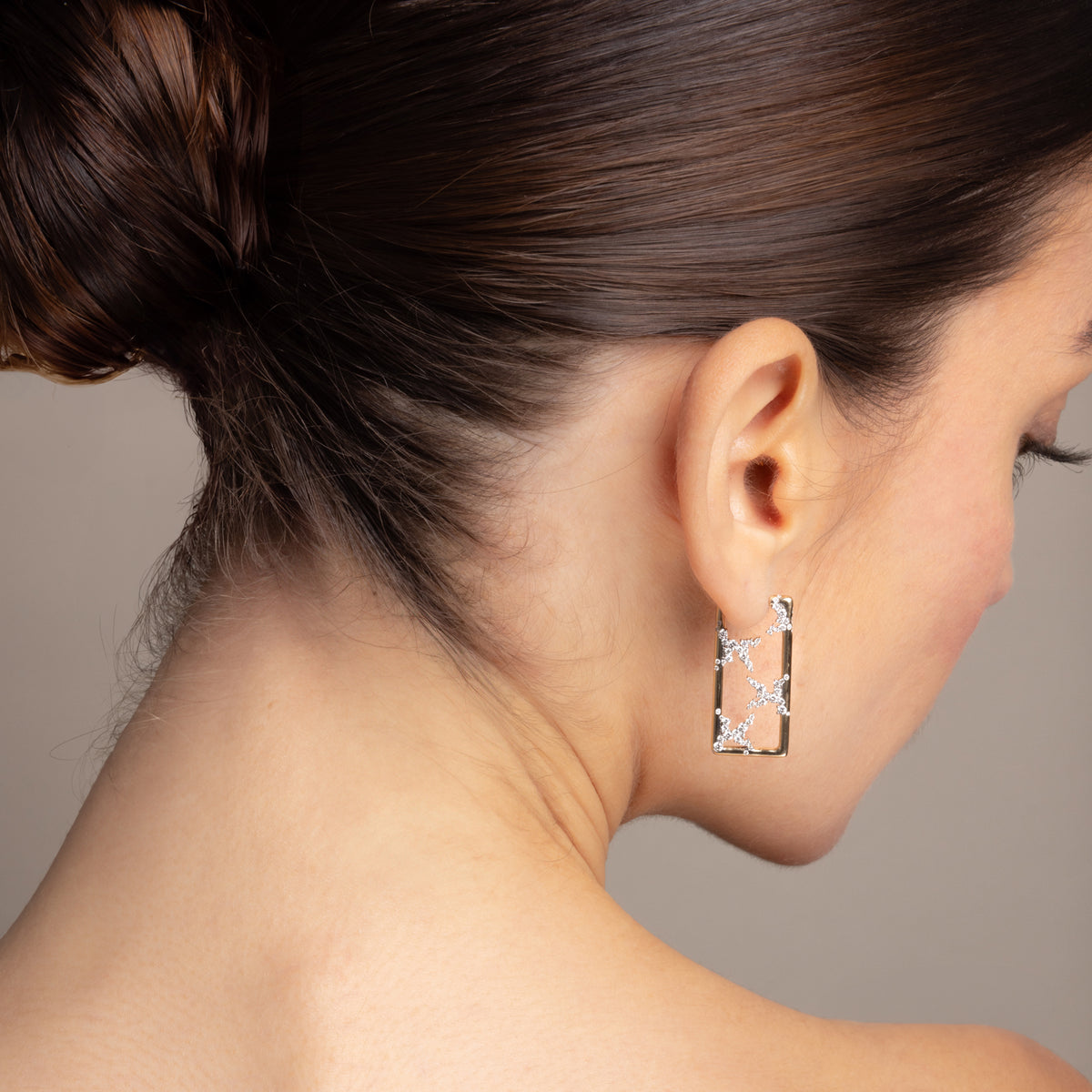 Model wearing the 14k yellow gold SAV diamond rectangle hoop earring at the lobe, shown in a clean rear three-quarter profile with hair up, against a neutral backdrop.