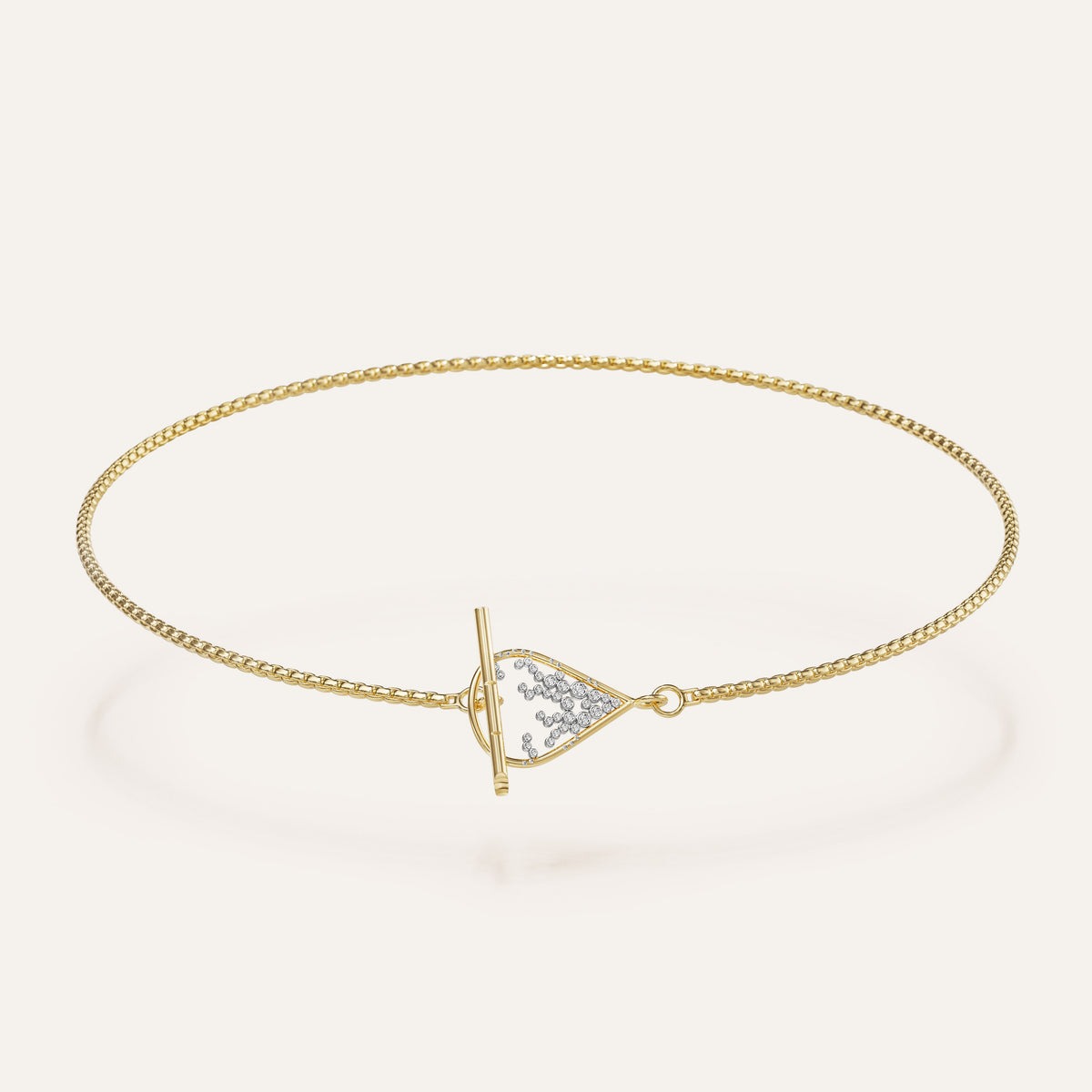 Gold bracelet with a triangle-shaped clasp on a light beige background