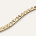 Gold bracelet with diamond accents on a white background