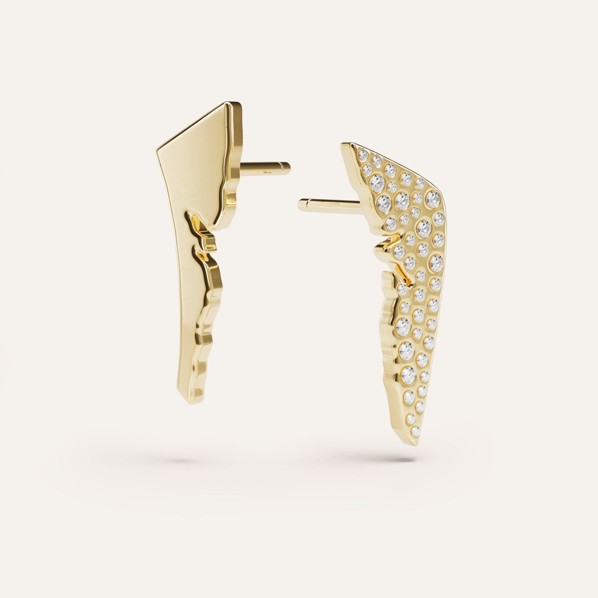 Gold wing-shaped earrings with diamond accents on a light gray background
