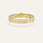 Gold bracelet with geometric pattern on a white background