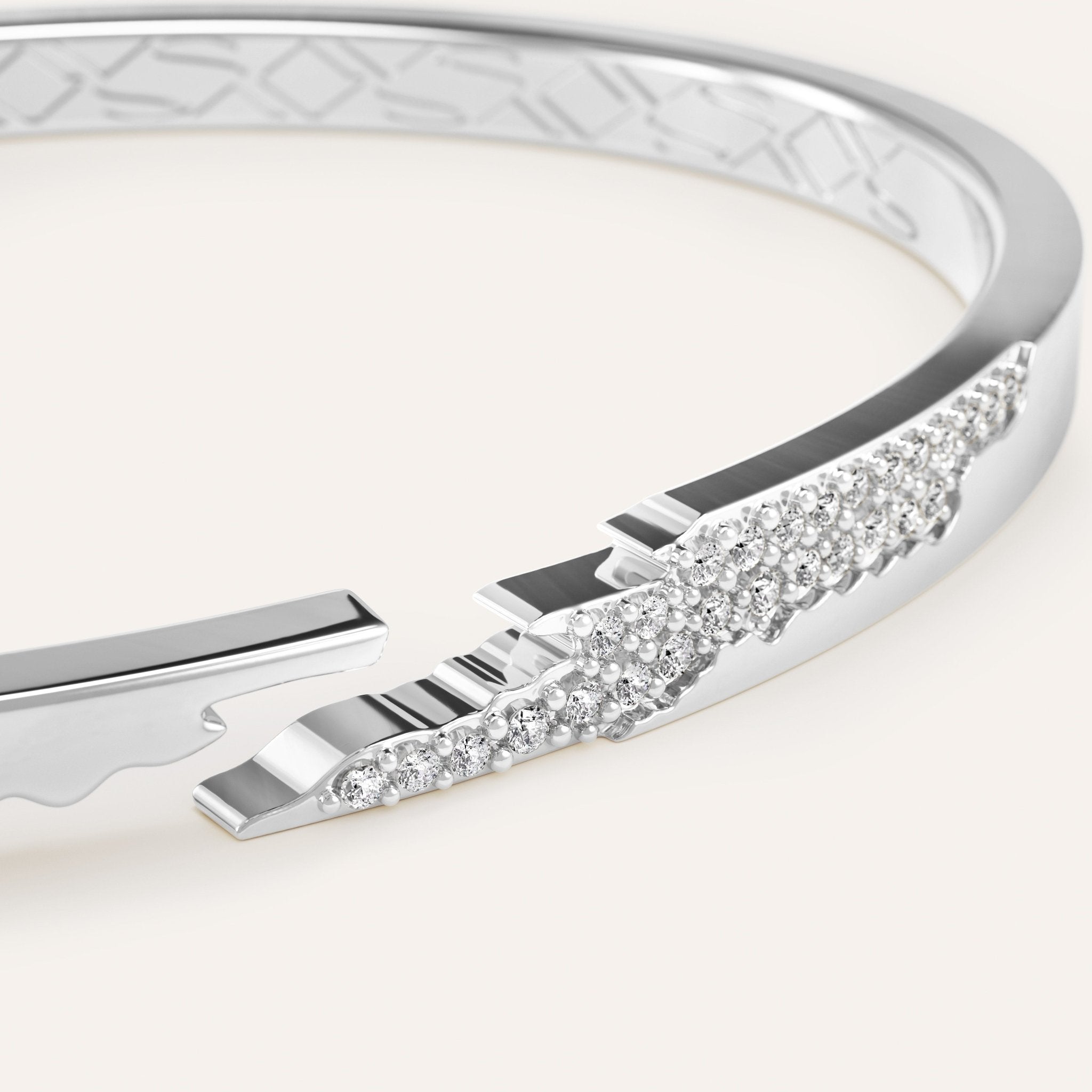 Silver bracelet with diamond accents on a light background