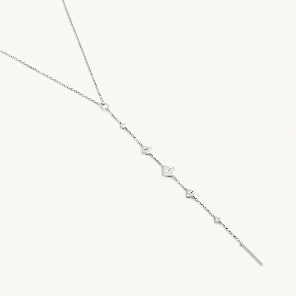 Silver necklace with small diamond-like pendants on a white background