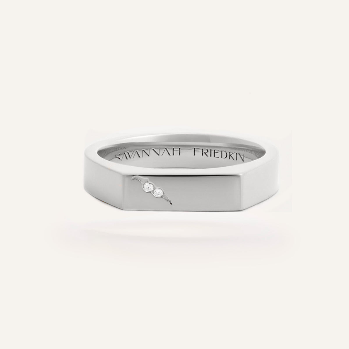 White gold lab-grown diamond signet ring with a flat octagonal face, two flush-set round brilliant lab-grown diamonds alongside a small engraved crack detail, and a 