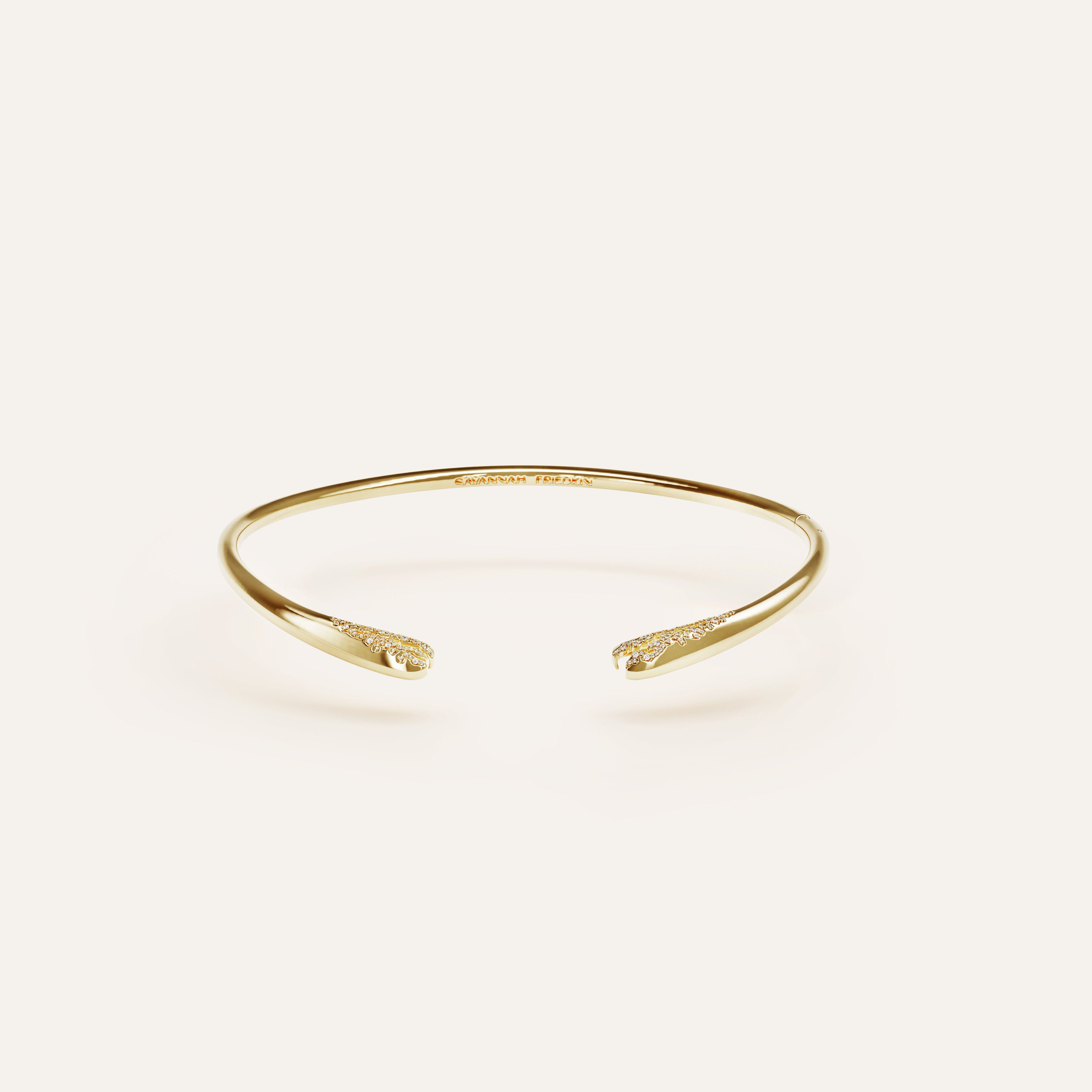 Gold bracelet on a light beige background