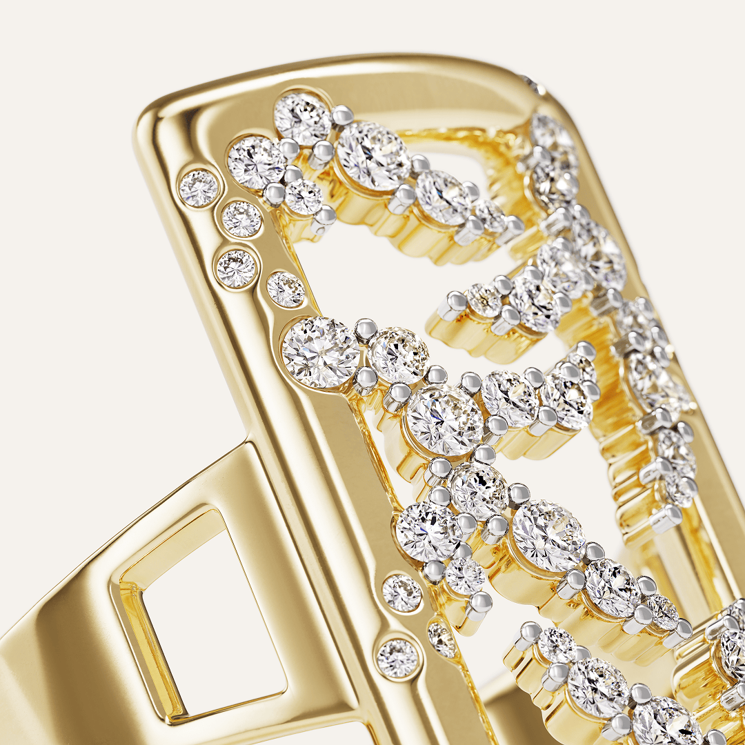Macro close-up of the 14k yellow gold SAV diamond rectangle ring, showing the prong-set diamond logo clusters, bezel-set frame border diamonds, and split shank shoulder cutout in sharp detail.