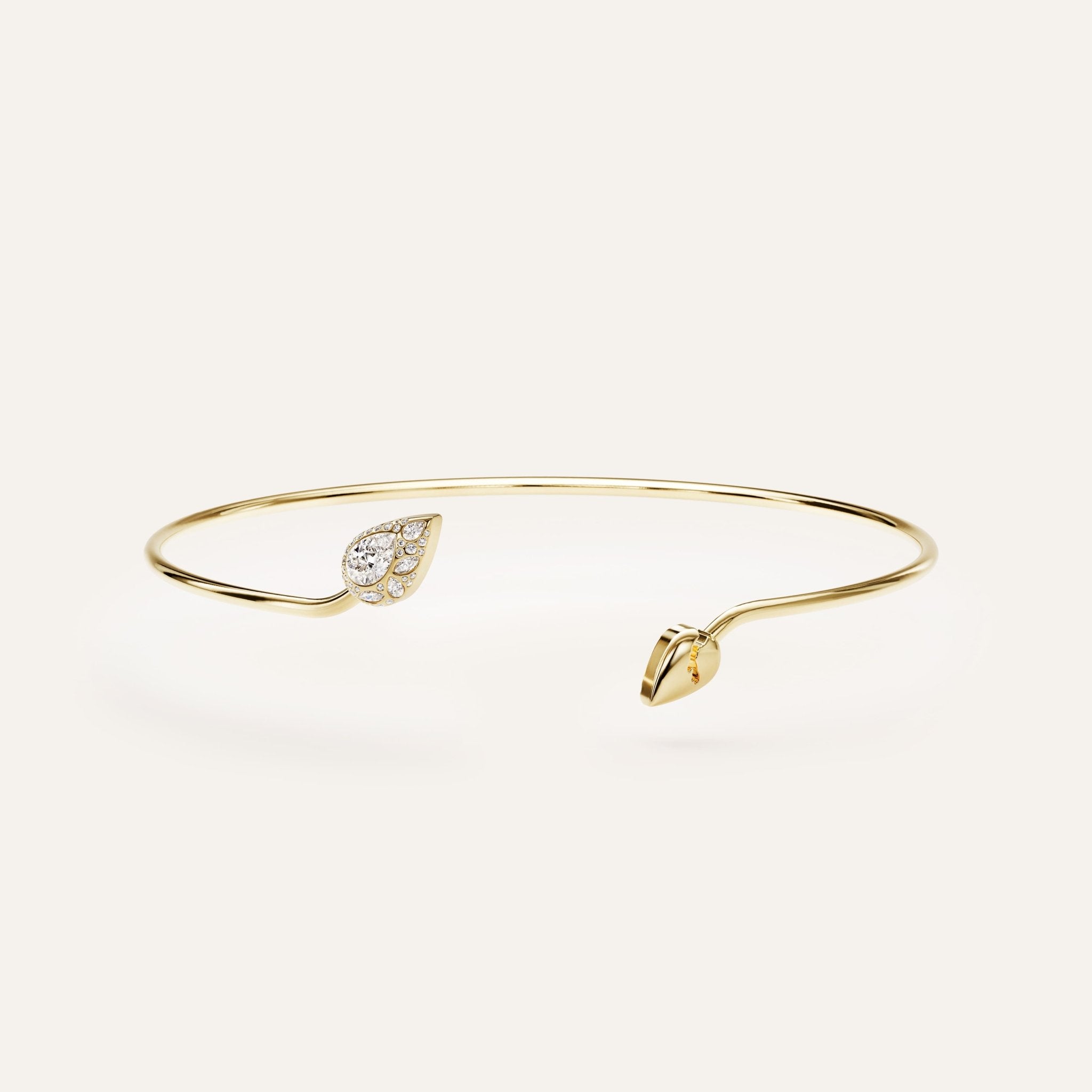 Gold bracelet with leaf designs on a light gray background